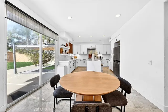 a view of a hallway with wooden floor and a bathroom