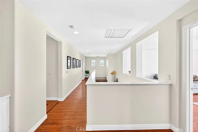 a view of a room with mirror and furniture