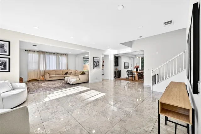 a living room with furniture and large windows