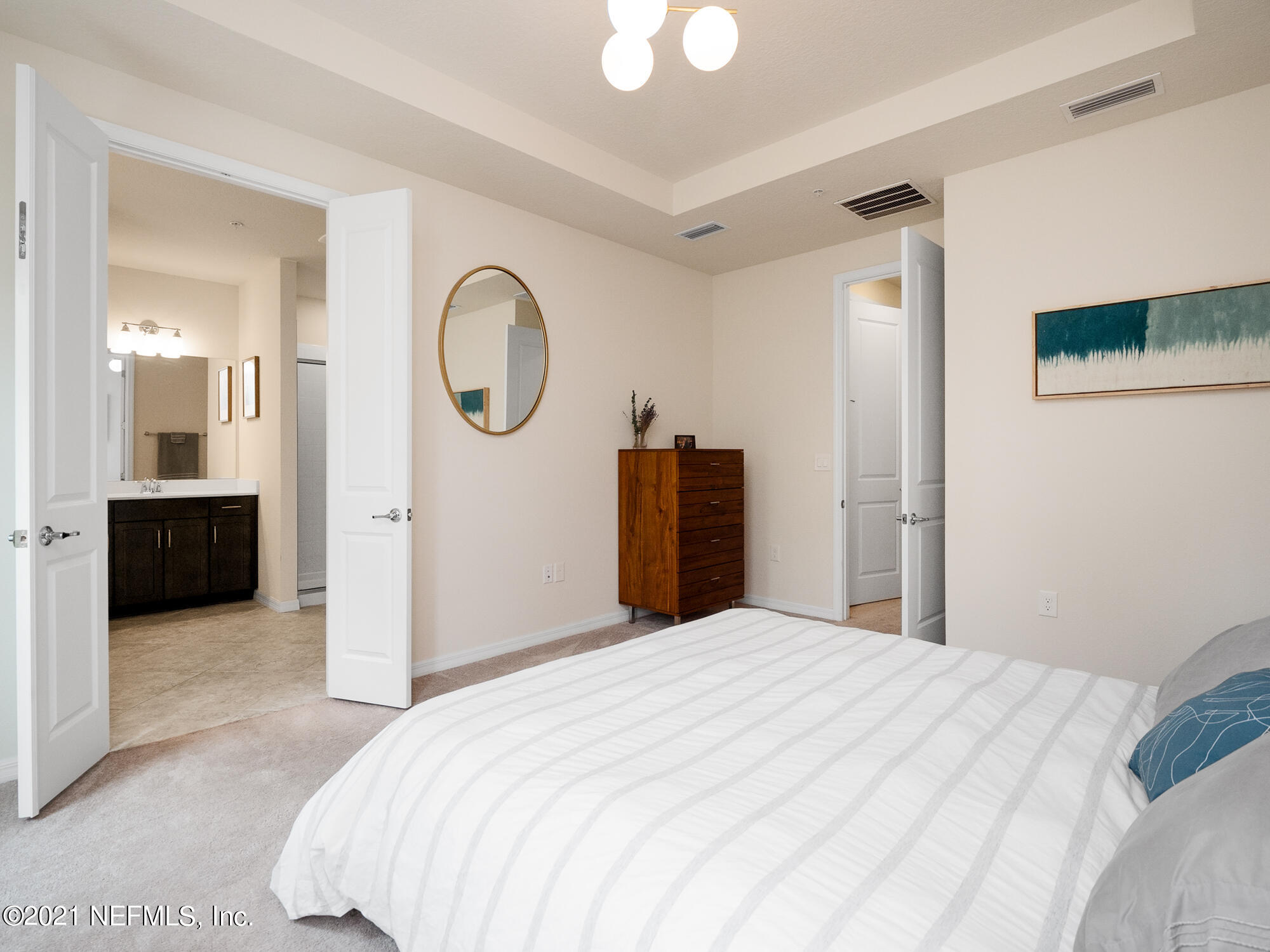 61 Spring Tide Way Ponte Vedra, FL 32081 - Photo 18 of 56 a bedroom with a bed and a mirror