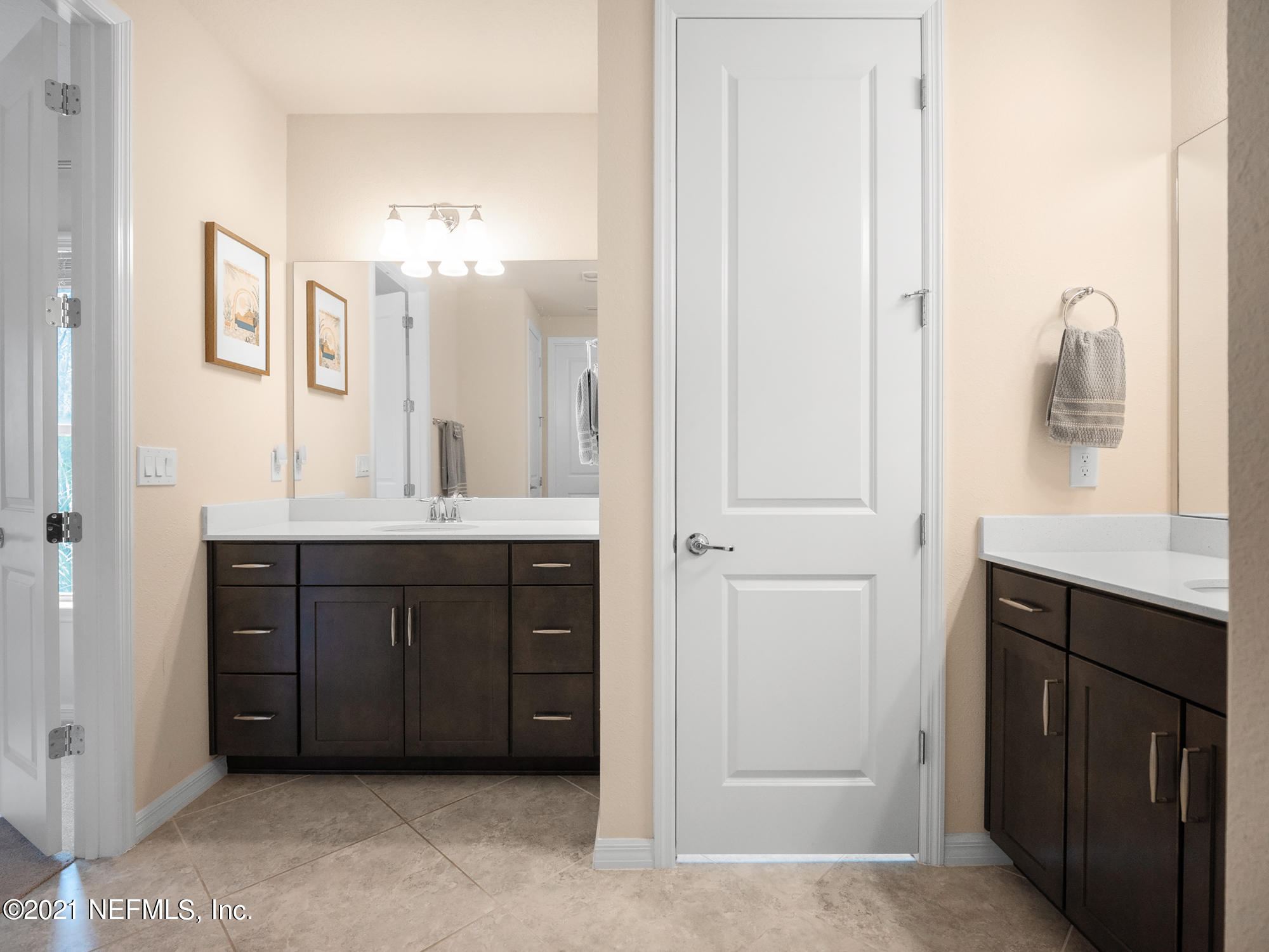 61 Spring Tide Way Ponte Vedra, FL 32081 - Photo 20 of 56 a bathroom with a double vanity sink a mirror and a