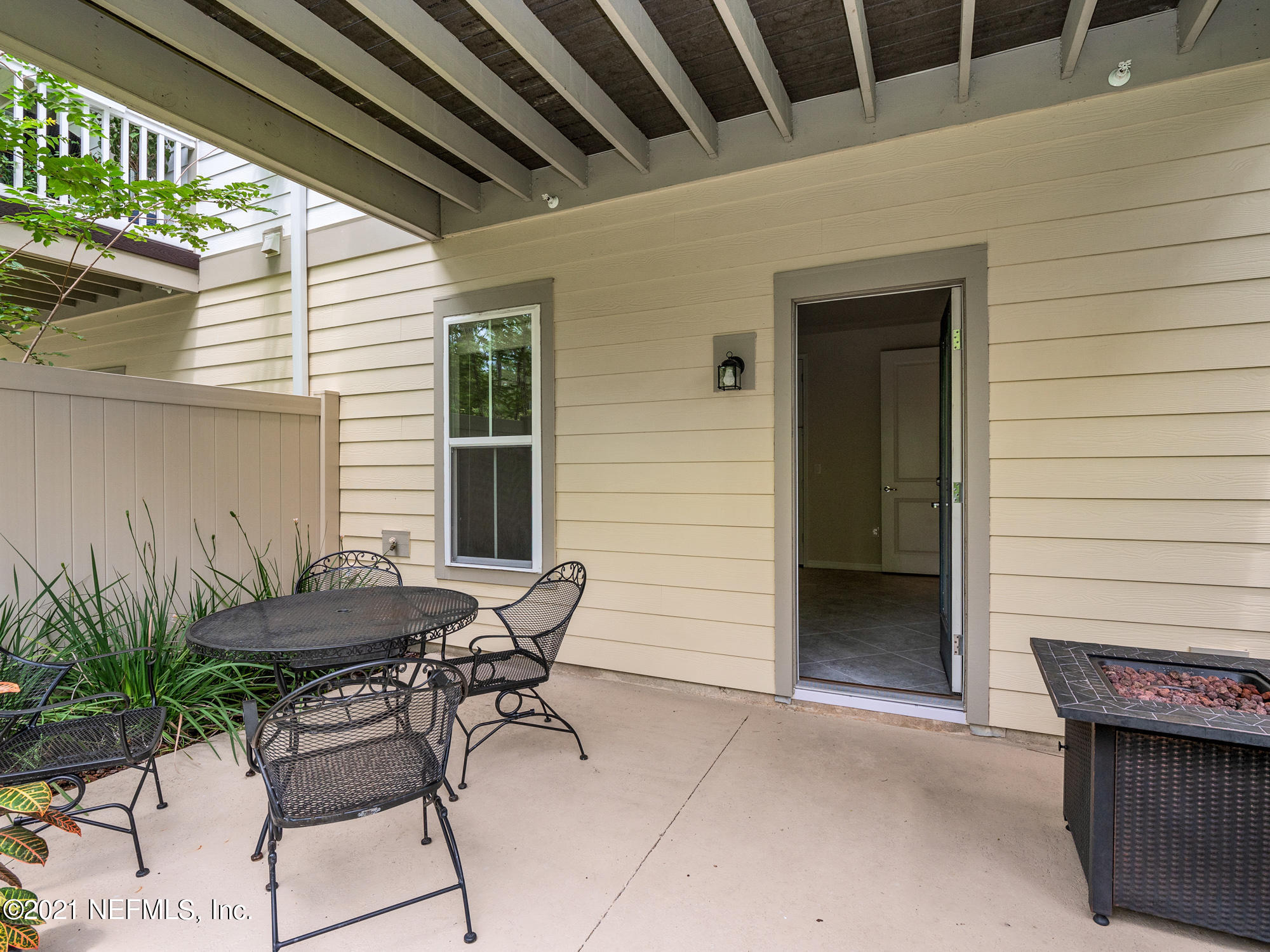 61 Spring Tide Way Ponte Vedra, FL 32081 - Photo 32 of 56 a patio with table and chairs and potted plants