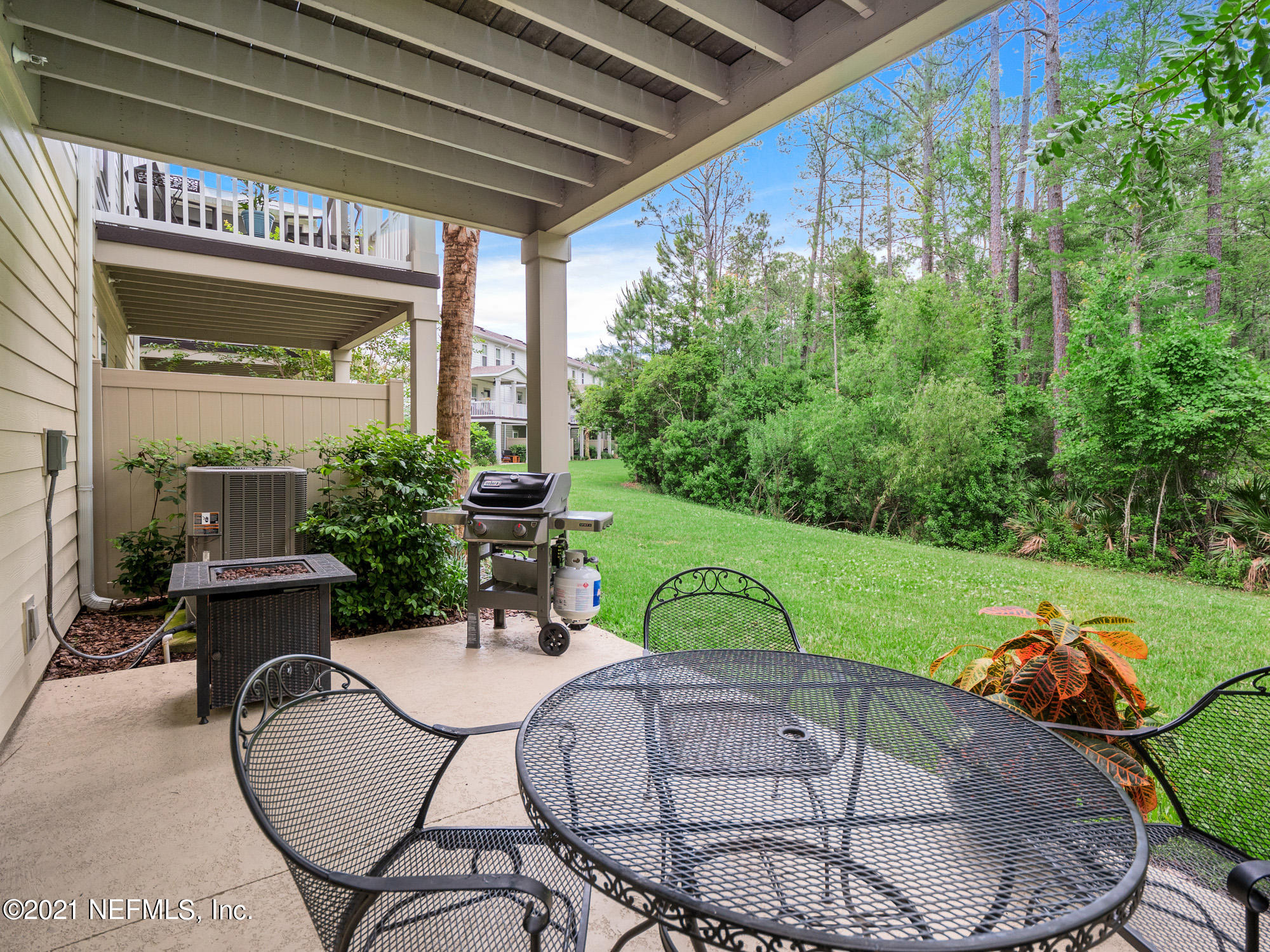 61 Spring Tide Way Ponte Vedra, FL 32081 - Photo 33 of 56 a view of a chairs and table in patio with a backyard