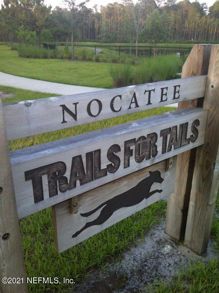 61 Spring Tide Way Ponte Vedra, FL 32081 - Photo 52 of 56 a view of a wooden fence with a bench in front of it