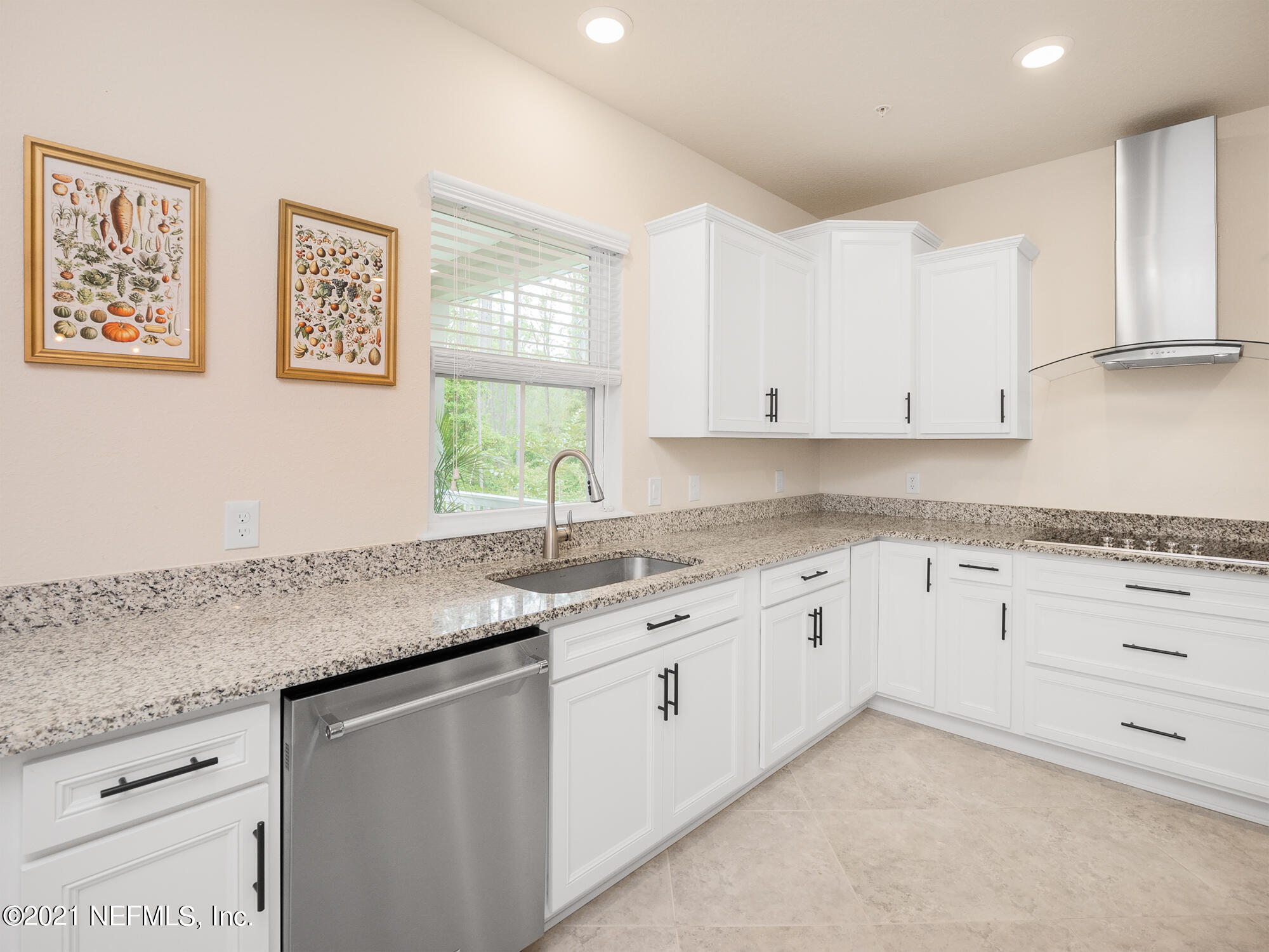 61 Spring Tide Way Ponte Vedra, FL 32081 - Photo 7 of 56 a kitchen with granite countertop white cabinets and white appliances