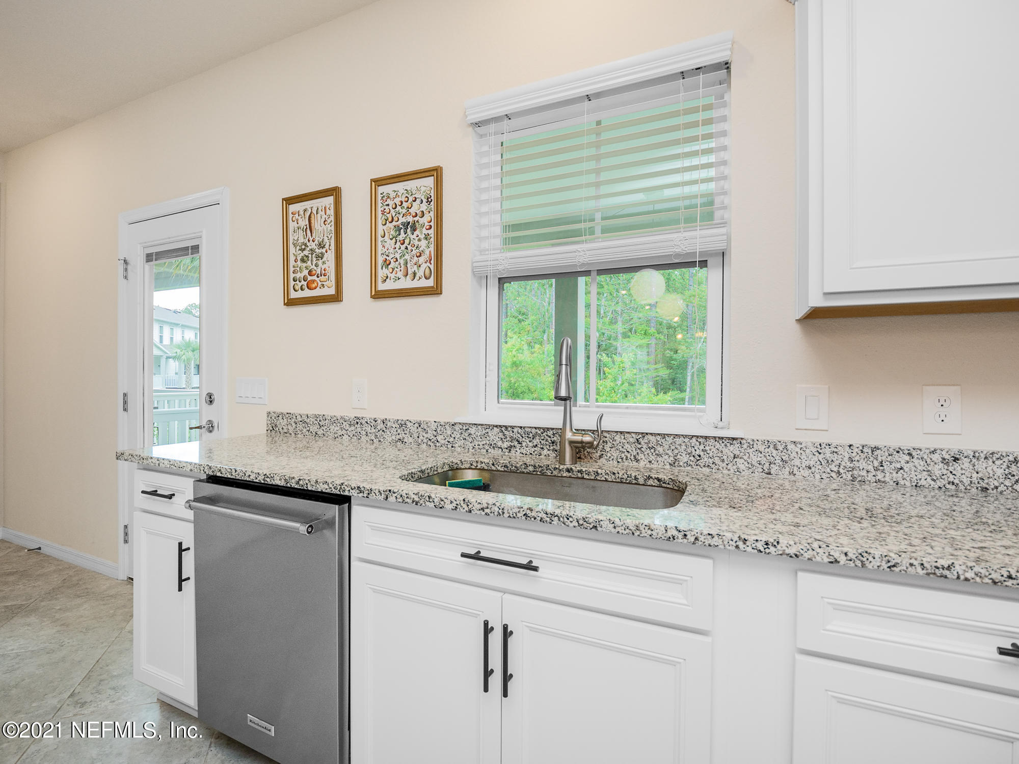 61 Spring Tide Way Ponte Vedra, FL 32081 - Photo 8 of 56 a kitchen with granite countertop cabinets sink and window