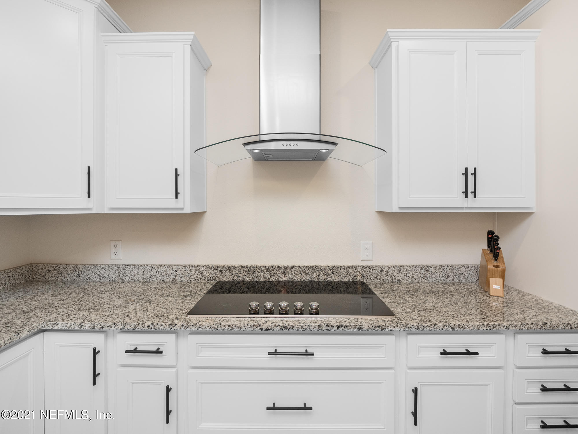 61 Spring Tide Way Ponte Vedra, FL 32081 - Photo 9 of 56 a kitchen with granite countertop white cabinets and a stove