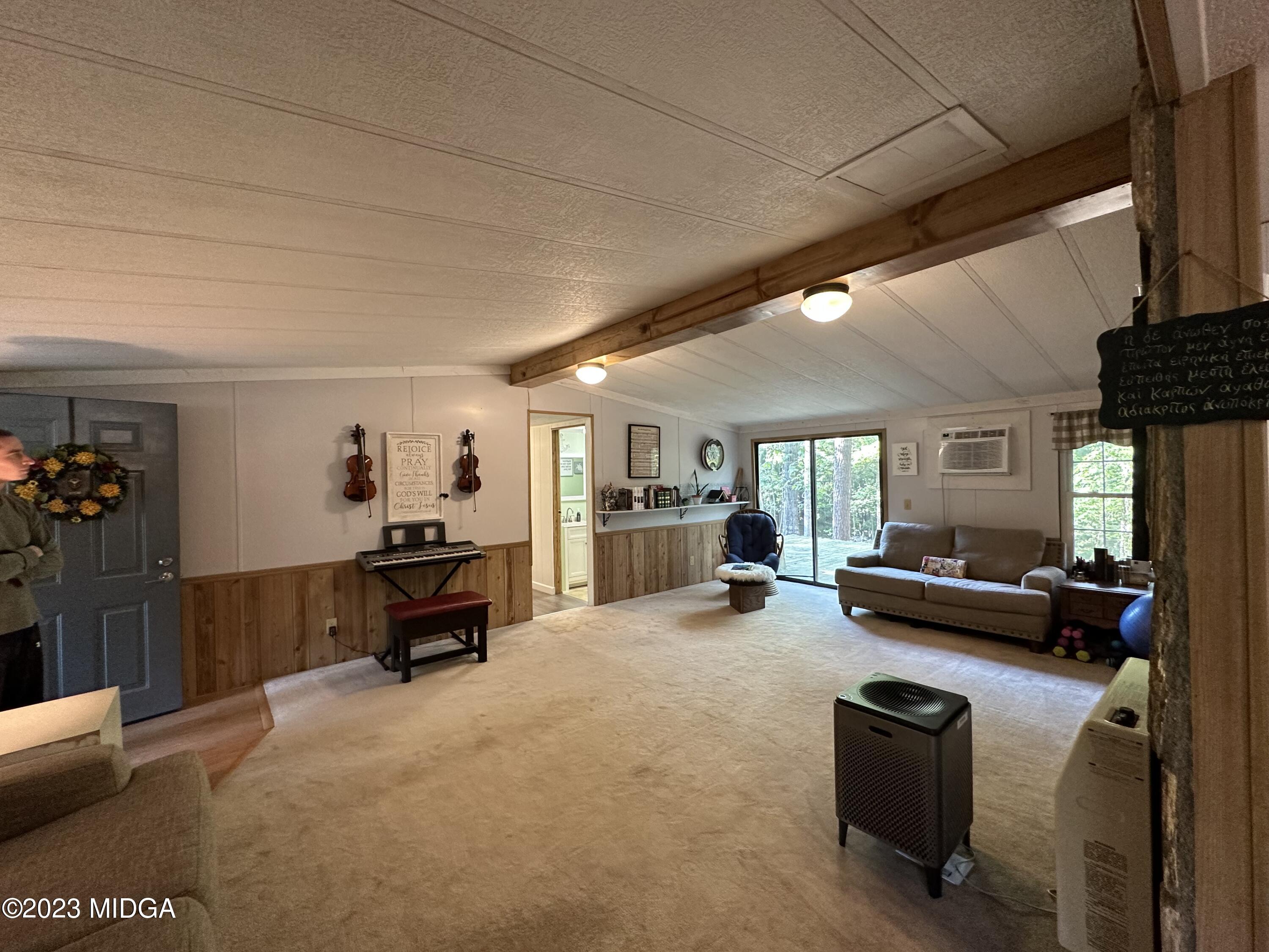 533 Giles Road Forsyth, GA 31029 - Photo 4 of 28 a living room with furniture and a flat screen tv