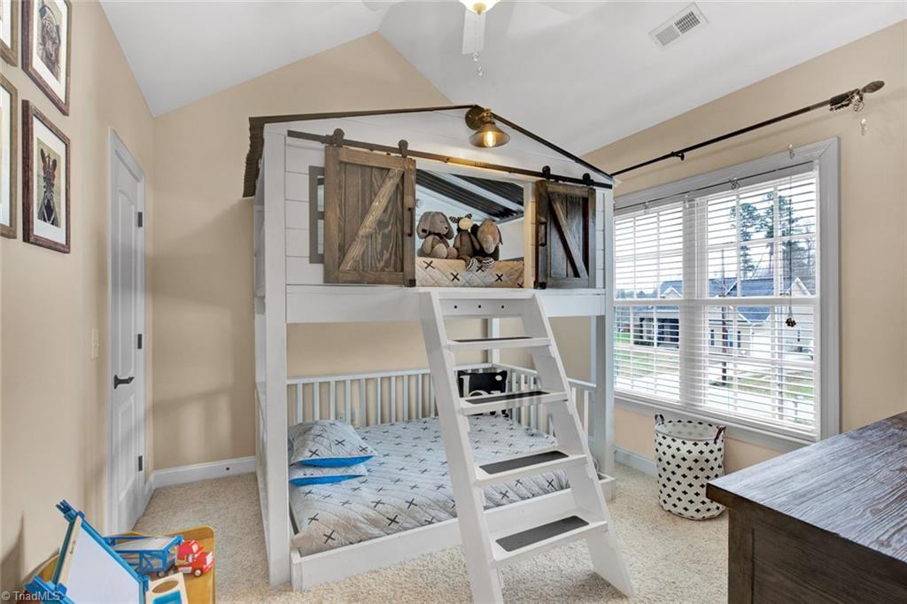 338 Homestead Avenue High Point, NC 27262 - Photo 19 of 25 upper level bedroom with vaulted ceiling