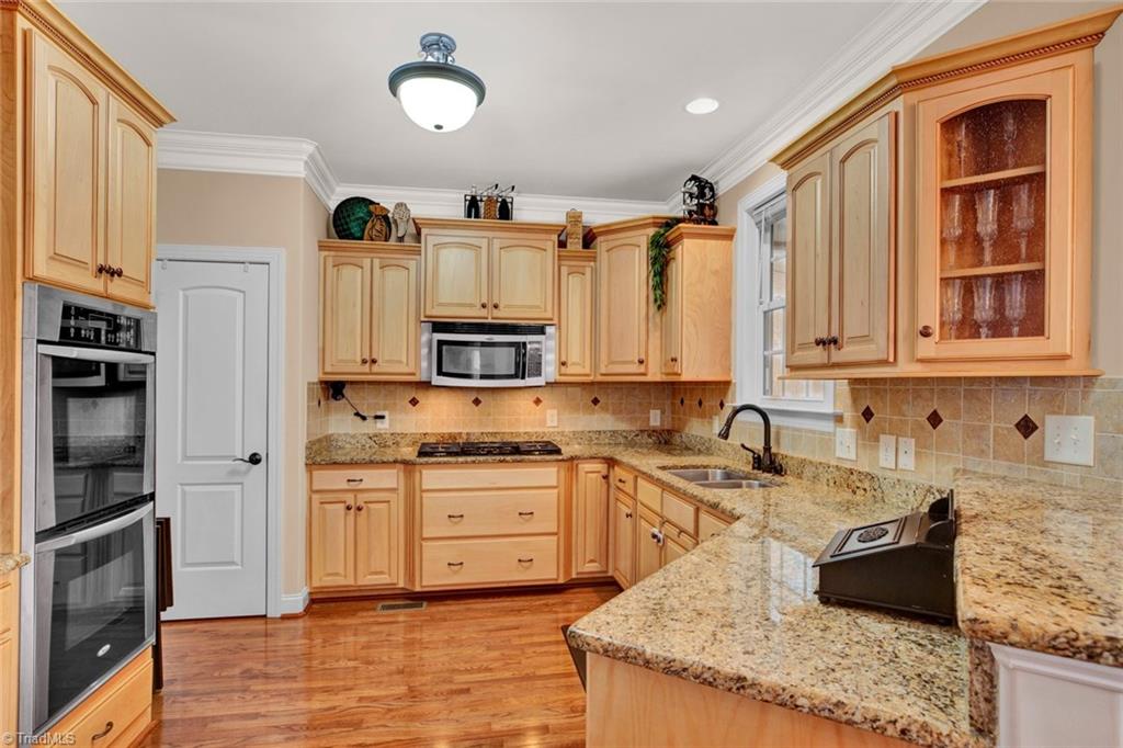 338 Homestead Avenue High Point, NC 27262 - Photo 8 of 25 Chef's kitchen with stainless appliances, double ovens, and granite countertops