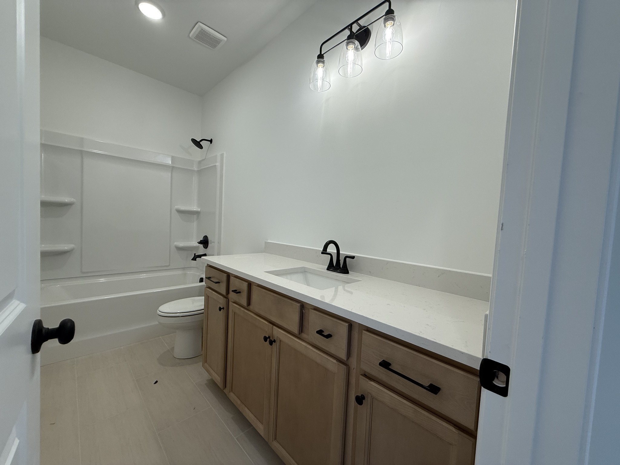 949 Brooklyn Xing Road Gallatin, TN 37066 - Photo 13 of 18 a bathroom with a granite countertop sink a toilet and shower
