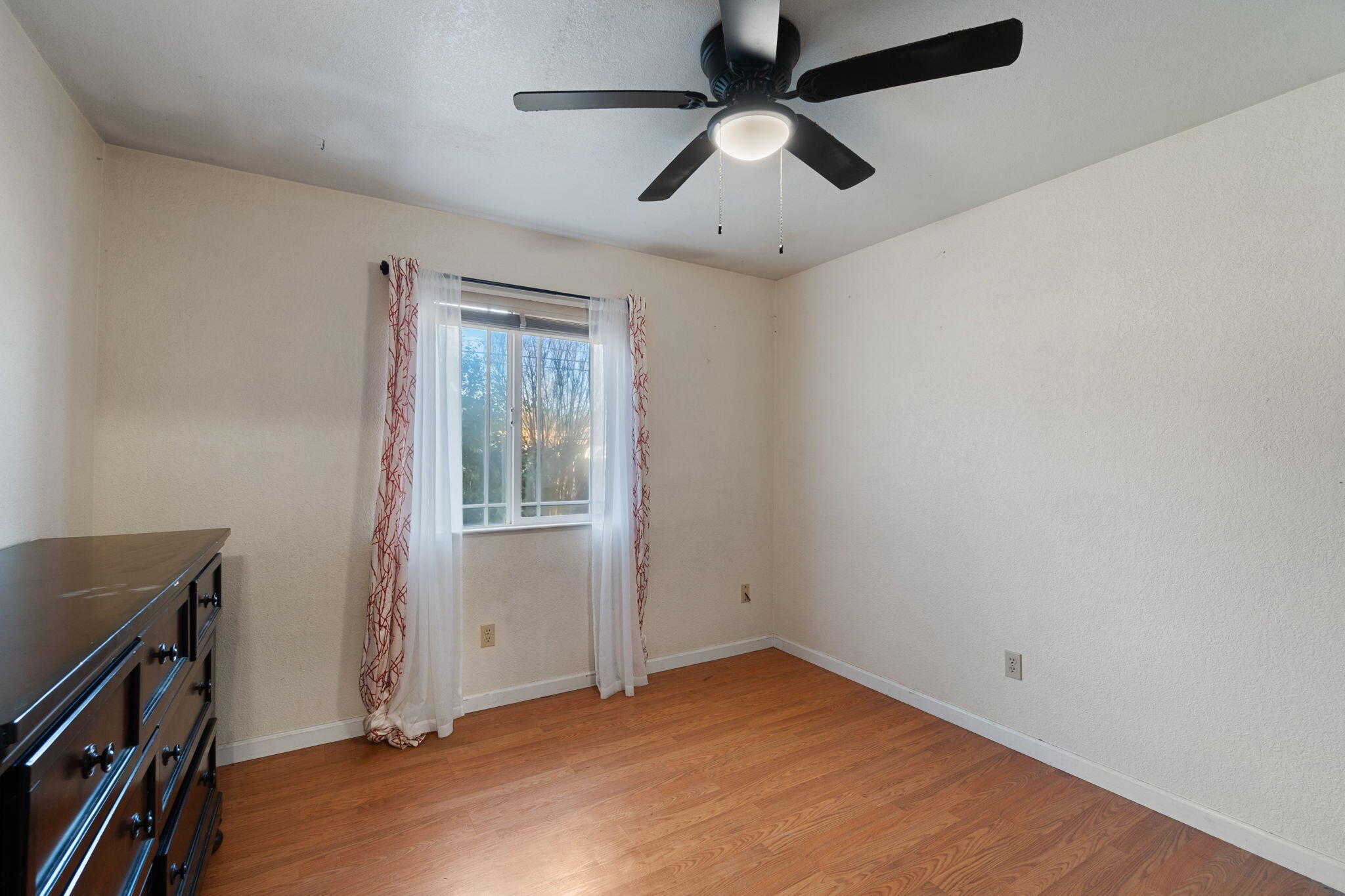 1971 Spruce Circle Anderson, CA 96007 - Photo 16 of 30 an empty room with a window and a ceiling fan