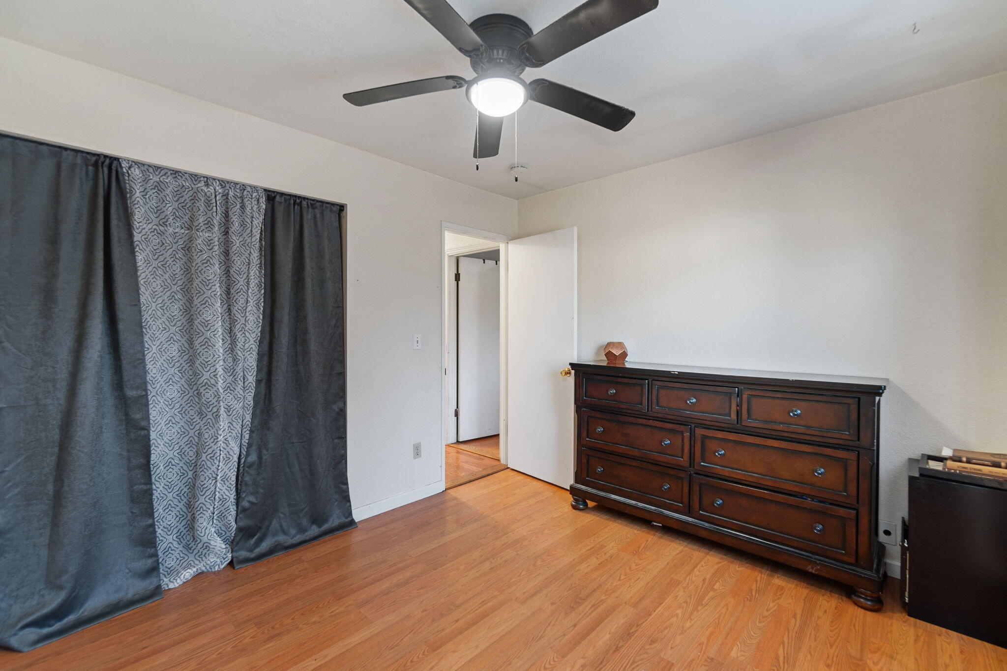 1971 Spruce Circle Anderson, CA 96007 - Photo 17 of 30 a room with a dresser and a ceiling fan