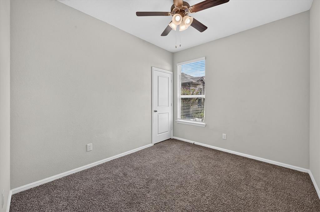 8812 Russano Road Fort Worth, TX 76131 - Photo 17 of 40 Neutral wall color, dark brown carpet, ceiling fan with integrated lighting, white trim, and a window with blinds