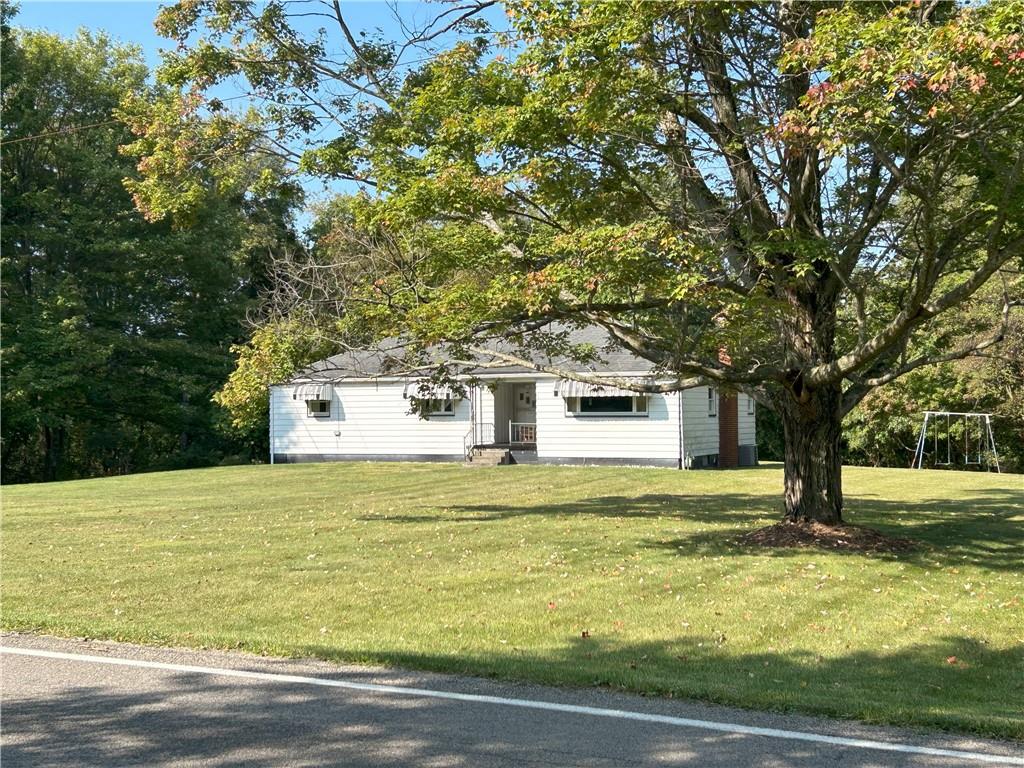 7831 Ridge Road Natrona Heights, PA 15065 - Photo 2 of 39 a front view of a house with a garden