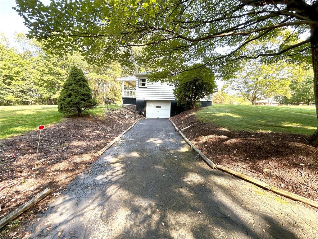 7831 Ridge Road Natrona Heights, PA 15065 - Photo 27 of 39 a view of a yard with plants and a large tree