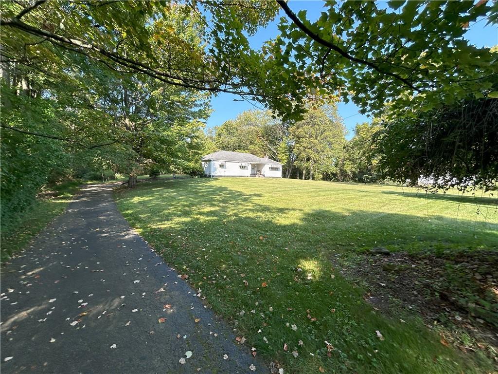 7831 Ridge Road Natrona Heights, PA 15065 - Photo 3 of 39 a view of a yard with plants and large trees