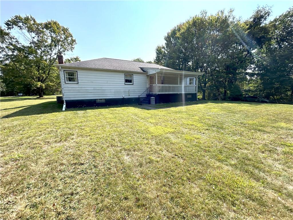 7831 Ridge Road Natrona Heights, PA 15065 - Photo 38 of 39 a front view of house with yard and trees in the background