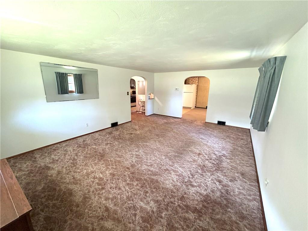 7831 Ridge Road Natrona Heights, PA 15065 - Photo 9 of 39 a view of a livingroom with wooden floor and a ceiling fan