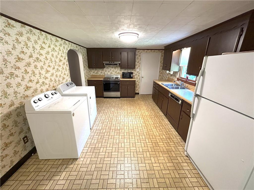 7831 Ridge Road Natrona Heights, PA 15065 - Photo 10 of 39 a kitchen with a refrigerator a stove top oven and a sink