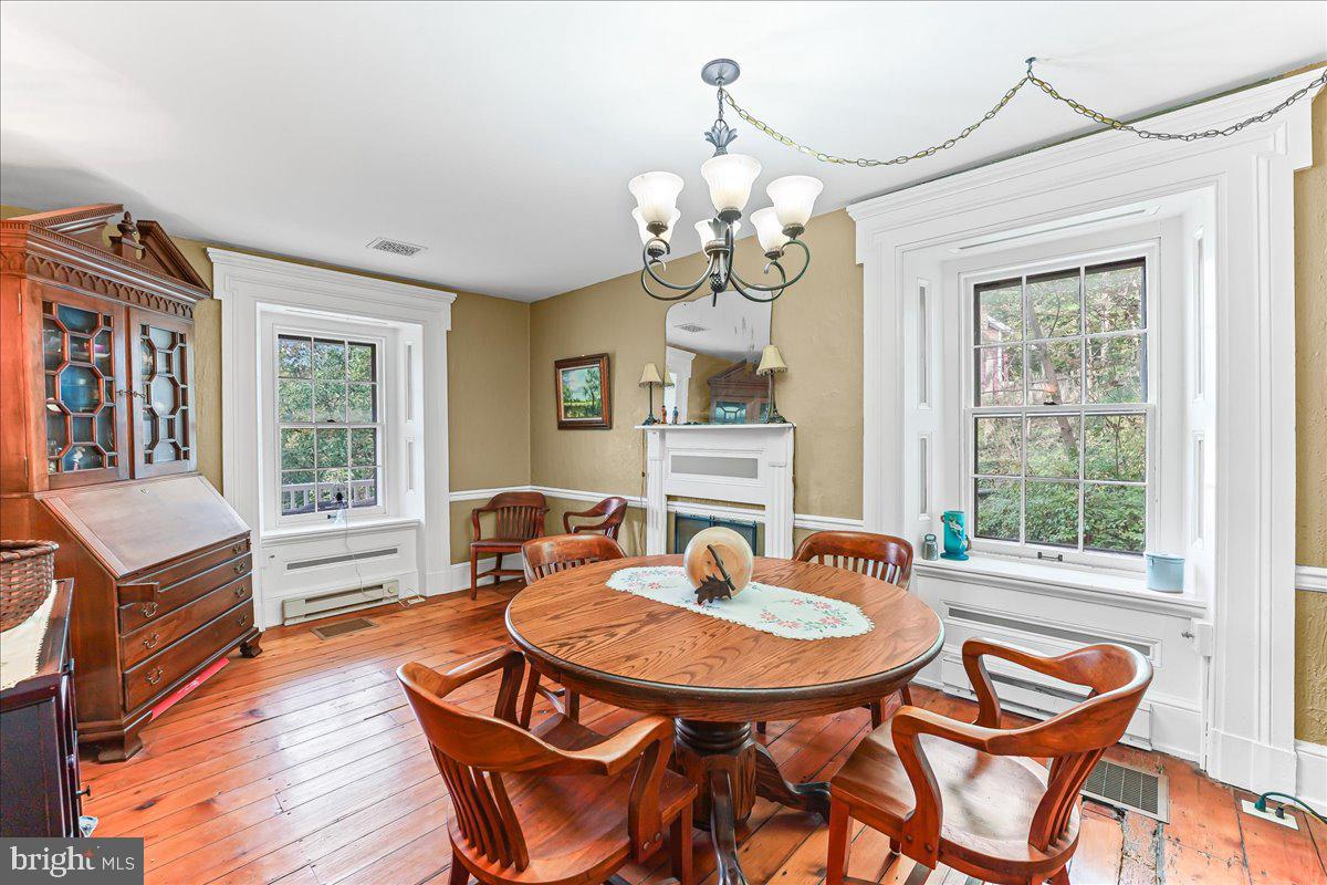 1420 Hollow Road Chester Springs, PA 19425 - Photo 18 of 43 a view of a dining room with furniture window and wooden floor