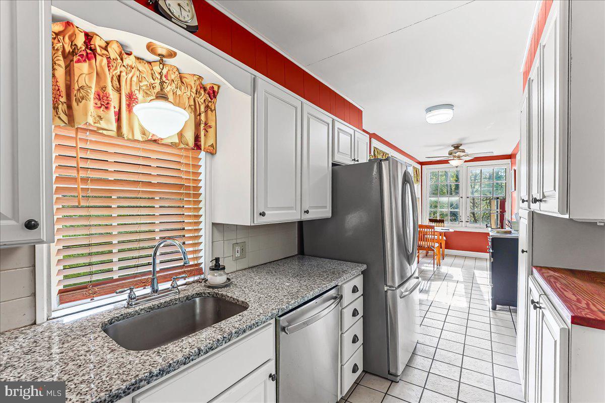 1420 Hollow Road Chester Springs, PA 19425 - Photo 21 of 43 a kitchen with stainless steel appliances granite countertop a sink a refrigerator and a stove