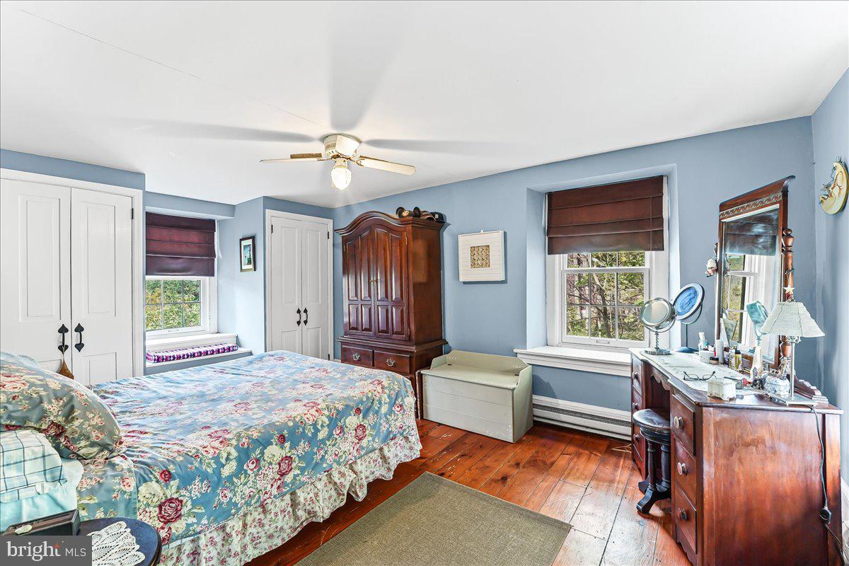 1420 Hollow Road Chester Springs, PA 19425 - Photo 29 of 43 a bedroom with a large bed couch and windows