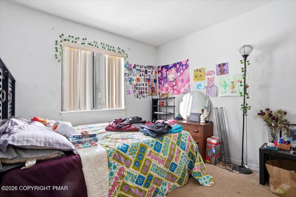 3322 Windermere Drive Bushkill, PA 18324 - Photo 22 of 52 a bedroom with a bed and a couch