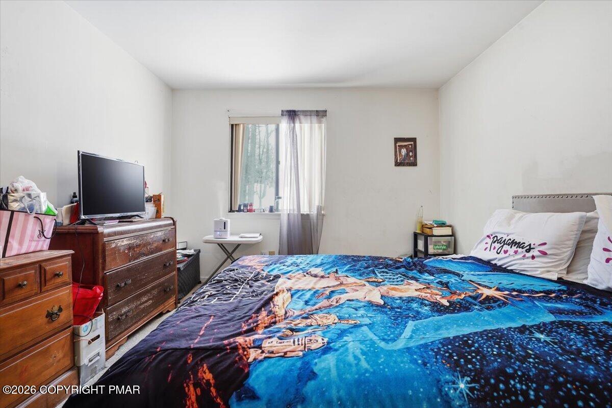 3322 Windermere Drive Bushkill, PA 18324 - Photo 25 of 52 a bedroom with a bed and flat screen tv