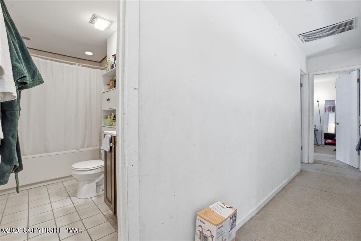 3322 Windermere Drive Bushkill, PA 18324 - Photo 27 of 52 a bathroom with a granite countertop toilet and a shower