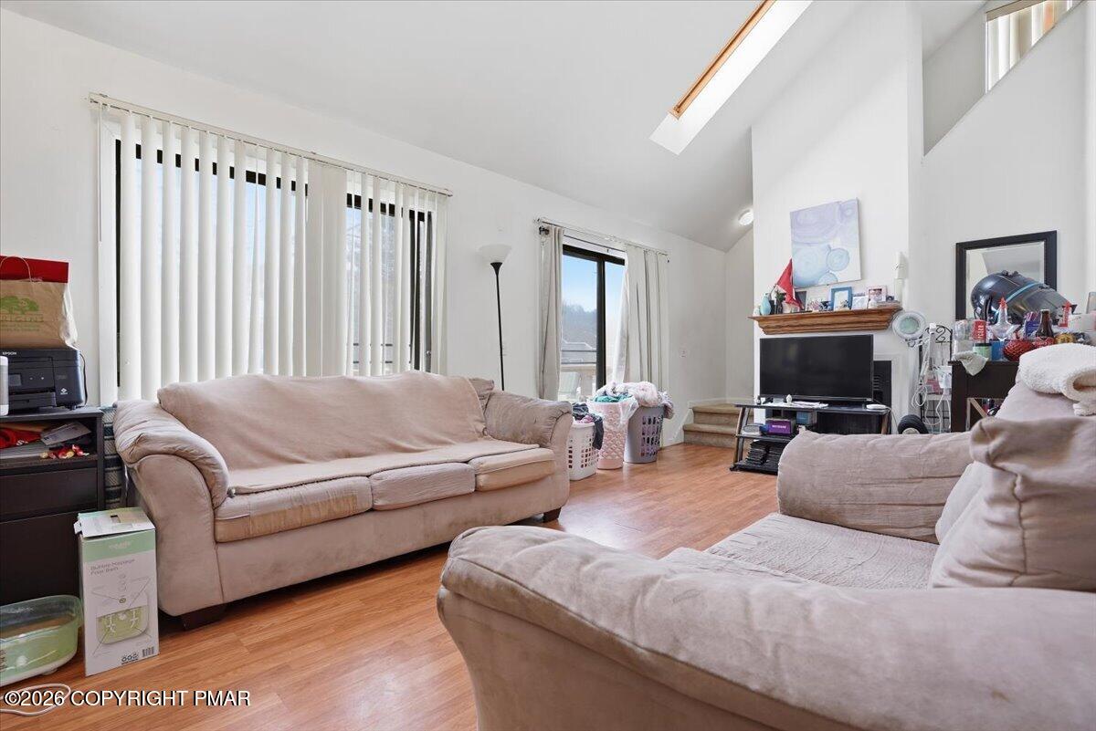 3322 Windermere Drive Bushkill, PA 18324 - Photo 5 of 52 a living room with furniture a fireplace and a flat screen tv
