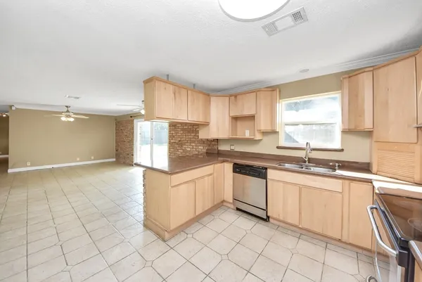 a kitchen with a sink cabinets and window