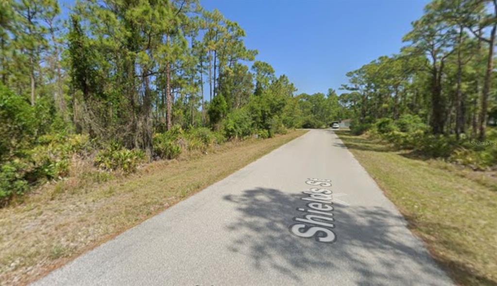 1365 Shields Street Punta Gorda, FL 33980 - Photo 4 of 14 a view of a yard with trees