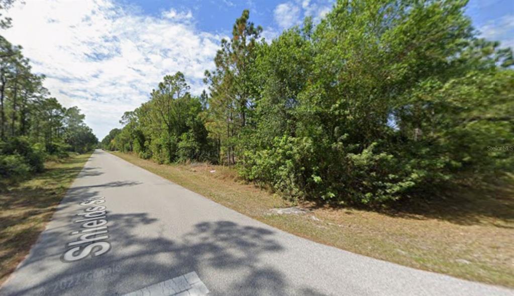 1365 Shields Street Punta Gorda, FL 33980 - Photo 6 of 14 a view of a road with a yard