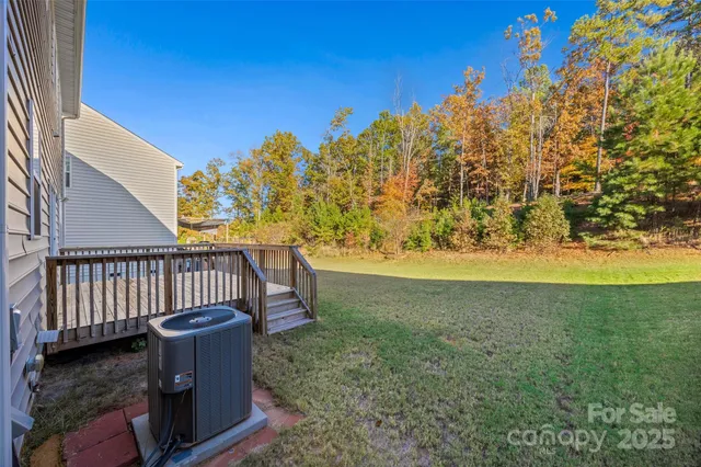 a view of a yard with wooden fence