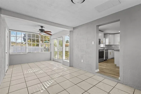 a view of a kitchen with furniture and an empty room