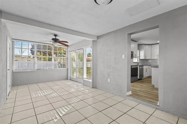 a view of a kitchen with furniture and an empty room