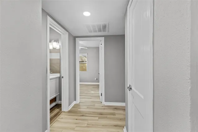 a view of hallway with wooden floor