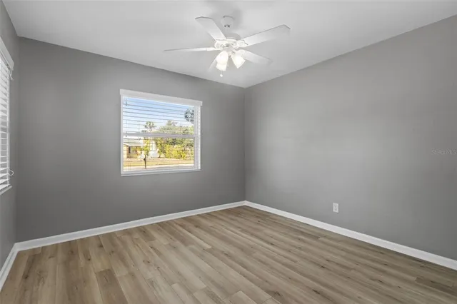 wooden floor in an empty room with a window