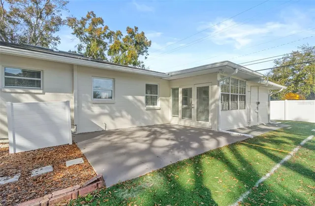 a view of a house with a yard and sitting area