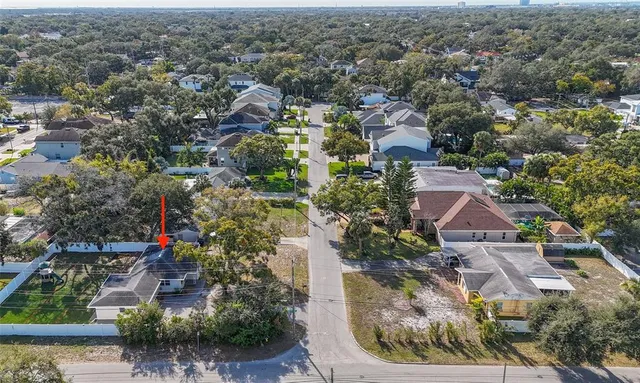 an aerial view of residential houses with outdoor space and street view