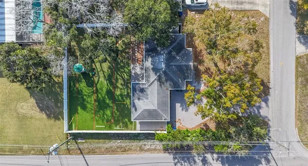 front view of a brick house with a yard