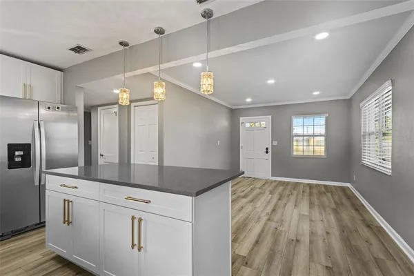 a view of a kitchen with a sink and refrigerator