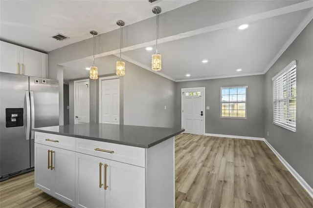 a view of a kitchen with a sink and refrigerator