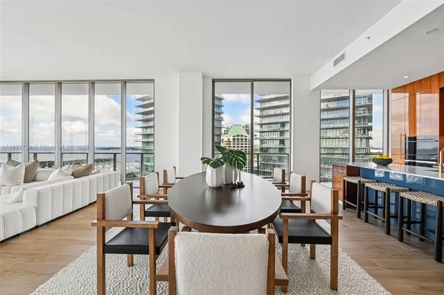 a view of a a dining room with furniture window and wooden floor