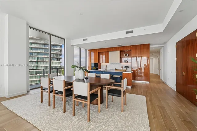 a dining room with furniture and wooden floor