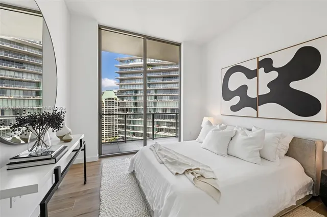 a bedroom with a bed and a mirror