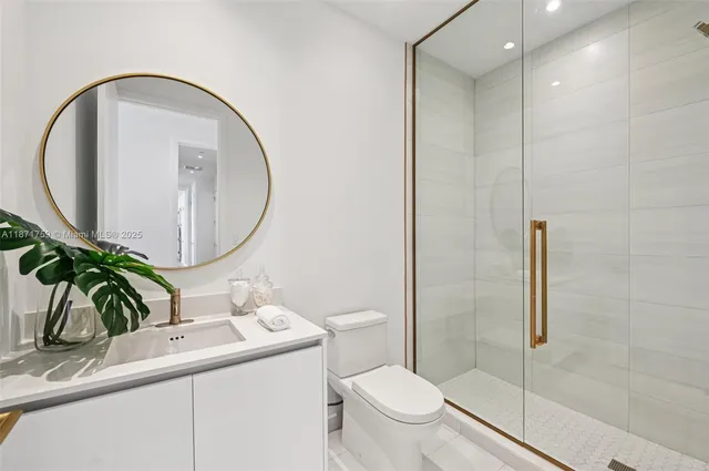 a bathroom with a toilet a sink and mirror