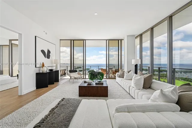 a living room with furniture and large windows