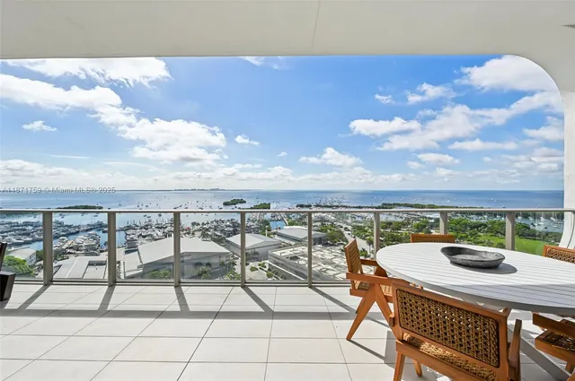 a view of a terrace with furniture and city view